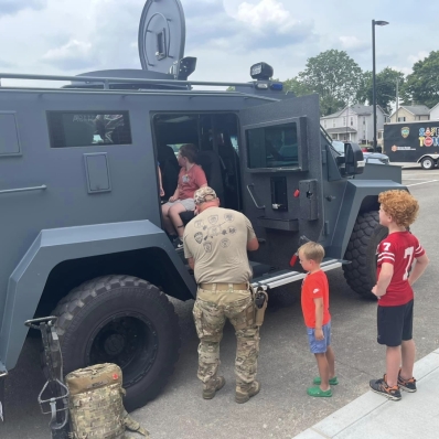 Children at Safety Town standing in line to get inside the SWAT vehicle